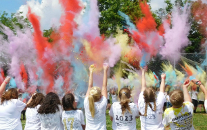 Students throw powdered dye into the air